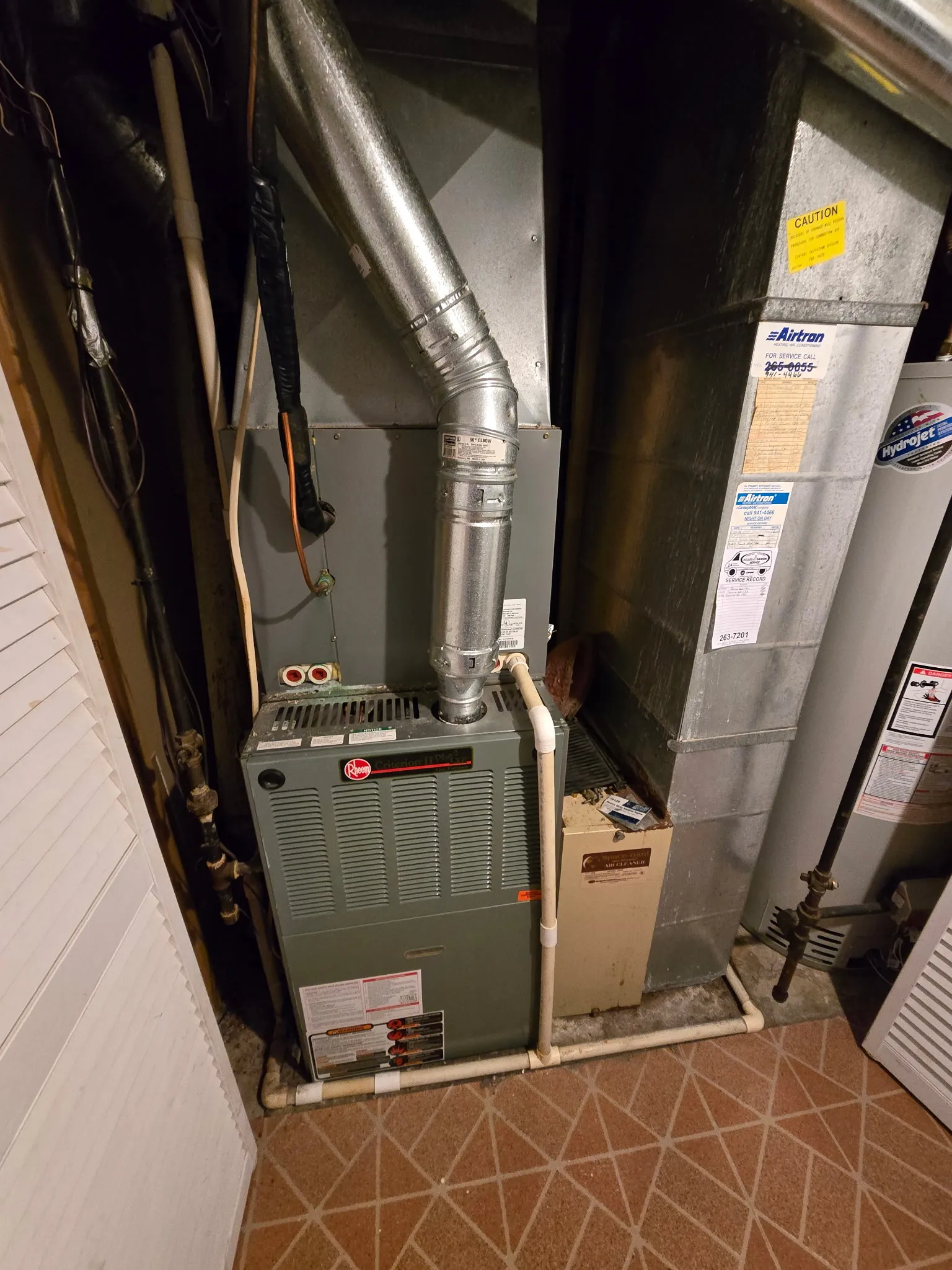 Rheem gas furnace with new flue venting installed in a basement utility room