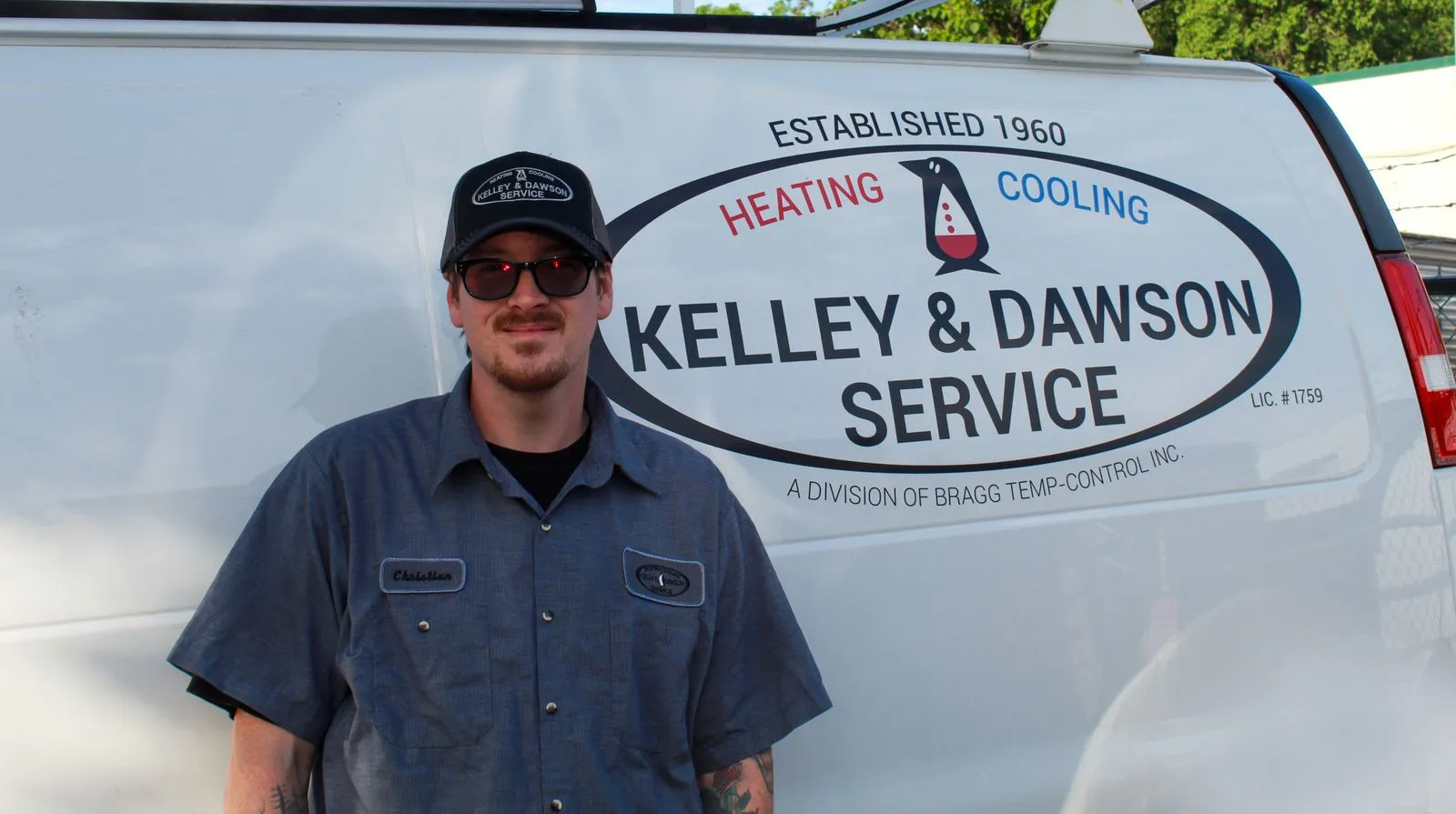Technician Christian beside a Kelley & Dawson Service van