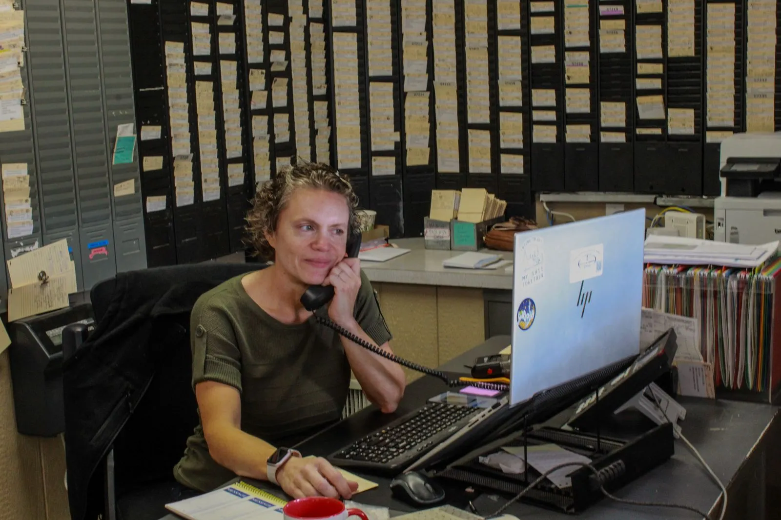 Office staff member answering customer calls at the Kelley & Dawson dispatch desk