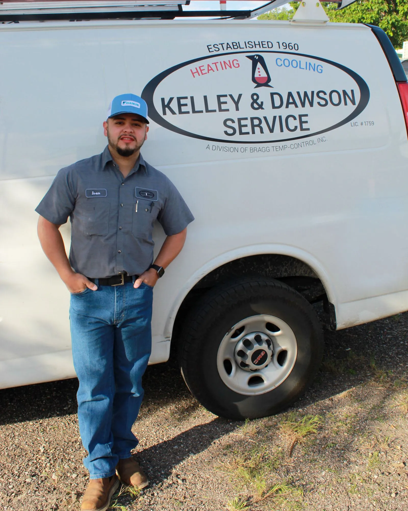 Technician Ivan standing beside a Kelley & Dawson Service van