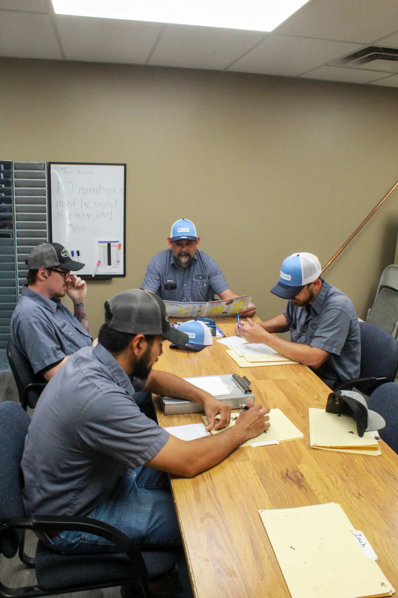 Kelley & Dawson technicians in a team meeting at the Wichita office